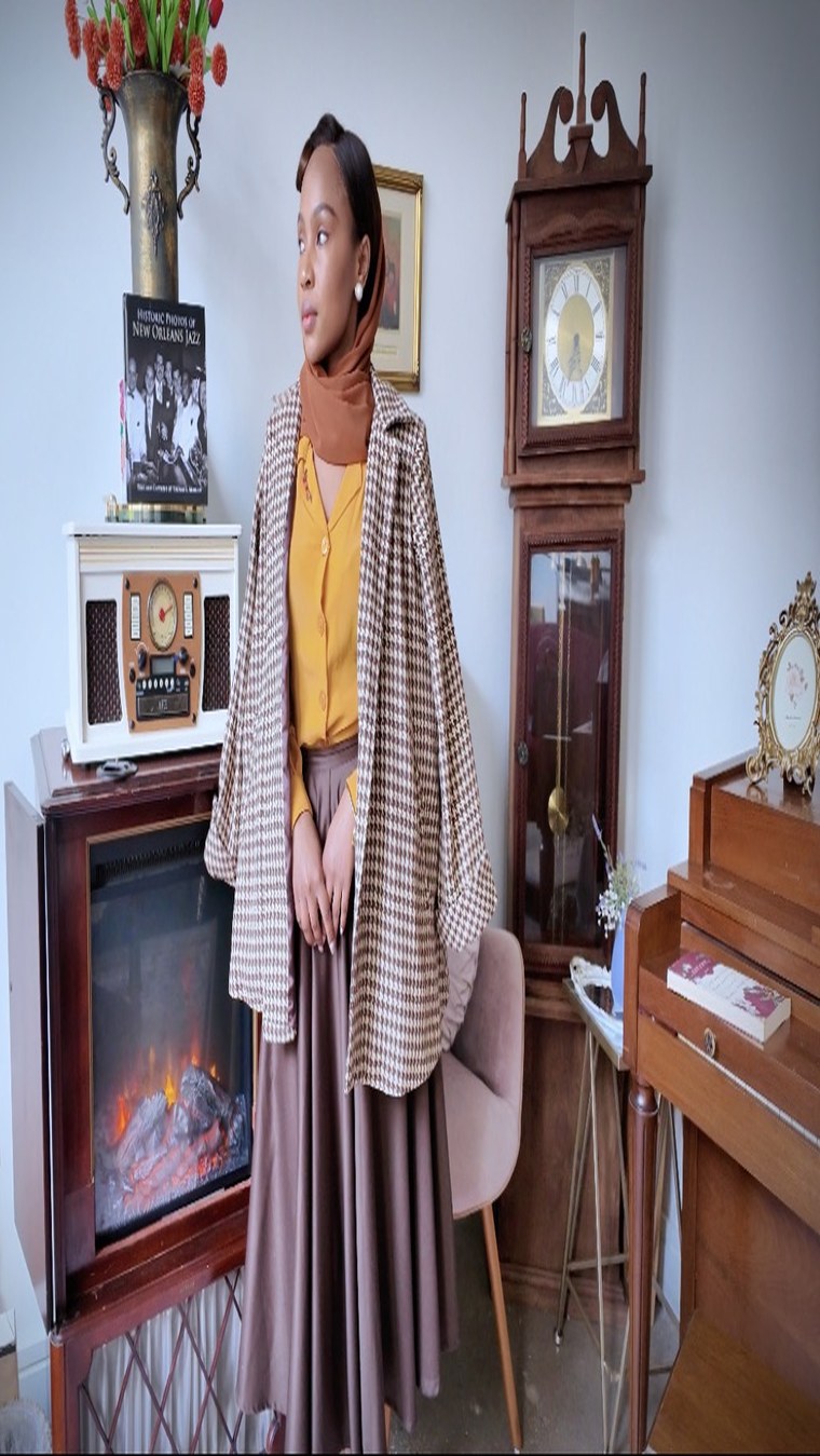 Houndstooth swing coat over a mustard blouse and headscarf