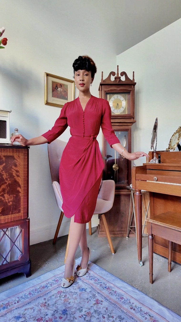 Red dress, front-facing, in a vintage-styled room